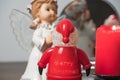 Angel with Santa Claus and lit red candles at Christmas or new year. December holidays and holidays
