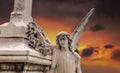 Angel sculpture against the dramatic orange sky