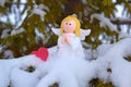 An angel on a snow-covered Christmas tree. Royalty Free Stock Photo