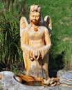 Angel statue fountain on a sunny day against a green background Royalty Free Stock Photo