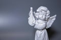 Angel statue isolated on white background. White stone sculpture of praying cherub