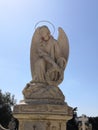 Angel statue over a grave in a cemetery