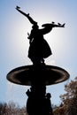 Angel statue silhouette with birds against sun Royalty Free Stock Photo