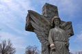 Angel Statue with Spread Wings on a Cross Looking Down in a Cemetery Royalty Free Stock Photo