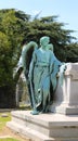 Angel Statue standing beside a funeral crypt