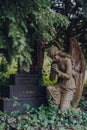 Angel statue by a tomb inside Hampstead Cemetery, London, UK