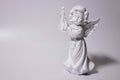 Angel statue on white background. White stone sculpture of praying cherub.