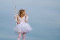 Angel teen with arrow and wings. Charming curly little girl in white dress and wings - angel cupid girl. St Valentines