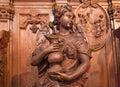 Angel with water wooden statue inside 17th century catholic church Saint Charles Borromeo