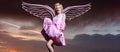 Angel woman with wings. Valentines day banner for website header design. Woman in pink dress on sunset, monroe style Royalty Free Stock Photo