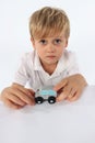 An angelic looking child boy showing his favorite simple wooden car toy Royalty Free Stock Photo