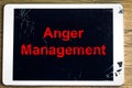 Anger Management message on a smashed and cracked tablet screen, anger management and frustrating technology concept