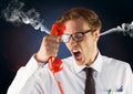 anger young man with steam on ears shouting to the phone. Black and blue background