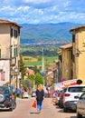 ANGHIARI, ITALY. Young woman in front of long straight ancient roman road in Tiber valley that connects Anghiari and Sa