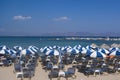 Sun beds and parasols on the beach at the beautiful Greek island oAgistri.os. Royalty Free Stock Photo