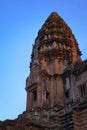 Angkor Wat, in Cambodia. Low angle view of one of the central towers at sunset against blue sky. Royalty Free Stock Photo