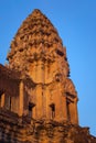 Angkor Wat, in Cambodia. Low angle view of one of the central towers at sunset against blue sky Royalty Free Stock Photo