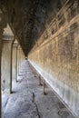 View along a corridor at Angkor wat. Originally constructed in the early 12th century, the ruins are a huge tourist attraction as Royalty Free Stock Photo