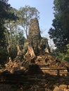 Angkor Wat in Siem Reap, Cambodia. Ancient ruins of Preah Palilay Khmer stone temple overgrown with the roots and giant trees Royalty Free Stock Photo