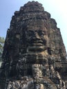 Angkor Wat in Siem Reap, Cambodia. Stone faces carved in the ancient ruins of Bayon Khmer Temple Royalty Free Stock Photo