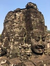 Angkor Wat in Siem Reap, Cambodia. Stone faces carved in the ancient ruins of Bayon Khmer Temple Royalty Free Stock Photo