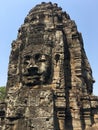 Angkor Wat in Siem Reap, Cambodia. Stone faces carved in the ancient ruins of Bayon Khmer Temple Royalty Free Stock Photo