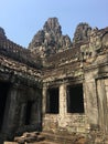 Angkor Wat in Siem Reap, Cambodia. Stone faces carved in the ancient ruins of Bayon Khmer Temple Royalty Free Stock Photo