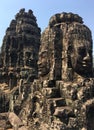 Angkor Wat in Siem Reap, Cambodia. Stone faces carved in the ancient ruins of Bayon Khmer Temple Royalty Free Stock Photo