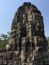 Angkor Wat in Siem Reap, Cambodia. Stone faces carved in the ancient ruins of Bayon Khmer Temple Royalty Free Stock Photo