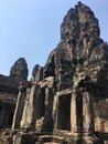 Angkor Wat in Siem Reap, Cambodia. Stone faces carved in the ancient ruins of Bayon Khmer Temple Royalty Free Stock Photo