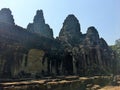 Angkor Wat in Siem Reap, Cambodia. Stone faces carved in the ancient ruins of Bayon Khmer Temple Royalty Free Stock Photo