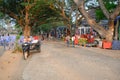 Angkor Wat - Stalls to sell souvenirs and refreshments for tourists. In the background you can see the temple complex of Angkor.