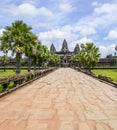 Angkor Wat temple Cambodia entrance path on a nice day blue sky with white fluffy clouds