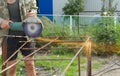 Angle Grinder Metal sawing with flashing sparks close up