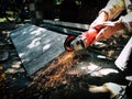 Angle grinder sparks angle grinder cutting steel. A worker cutting steel in concrete sheet with grinder.