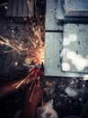 Angle grinder sparks angle grinder cutting steel. A worker cutting steel in concrete sheet with grinder.