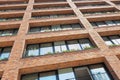 Angle point of view on a modern brick apartment building facade perspective with panoramic windows