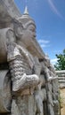 Angle the temple guardian sculpture under blue sky