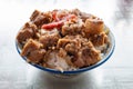 bowl of rice with pork ribs and slices of Chinese style sausage