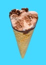 angle view of chocolate flavor ice cream cone with a bite on a blue background Royalty Free Stock Photo