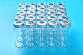 empty vaccine bottles on blue background Royalty Free Stock Photo