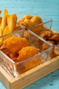 french fries and deep fried shrimps and chicken nuggets and popcorn chicken vertical composition Royalty Free Stock Photo