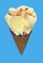 angle view of fresh pineapple ice cream cone with a big bite on blue background Royalty Free Stock Photo