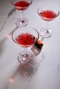 Angle view of glasses of cocktail and cork on white background