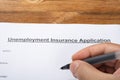 man filling up an unemployment insurance application