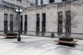 Angle view of open courtyard with vintage block building featuring art deco design and barren trees