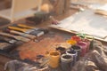 Angle view picture of an old palette with oil paints and gouache set. Clean painter workplace ready for drawing. Royalty Free Stock Photo