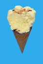 vanilla flaovr ice cream cone with a big bite on a blue background Royalty Free Stock Photo
