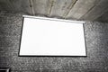Angle view of white projector screen on gray brick wall Royalty Free Stock Photo