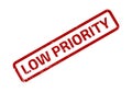 Angled Red Low Priority Stamp Distressed on a White Background Showing Scratches Royalty Free Stock Photo